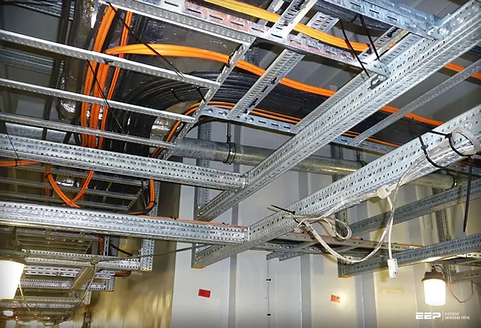 Exposed ceiling with cable trays and building services during an office fit-out