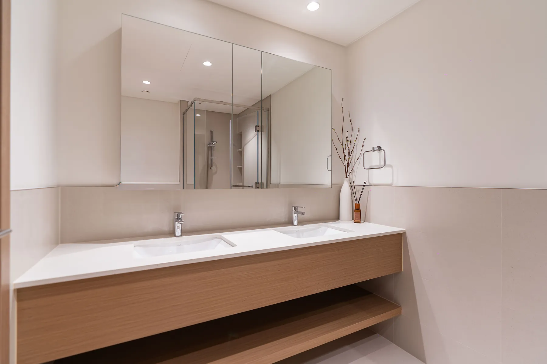 Bathroom with timber double vanity and mirrored wall cabinets