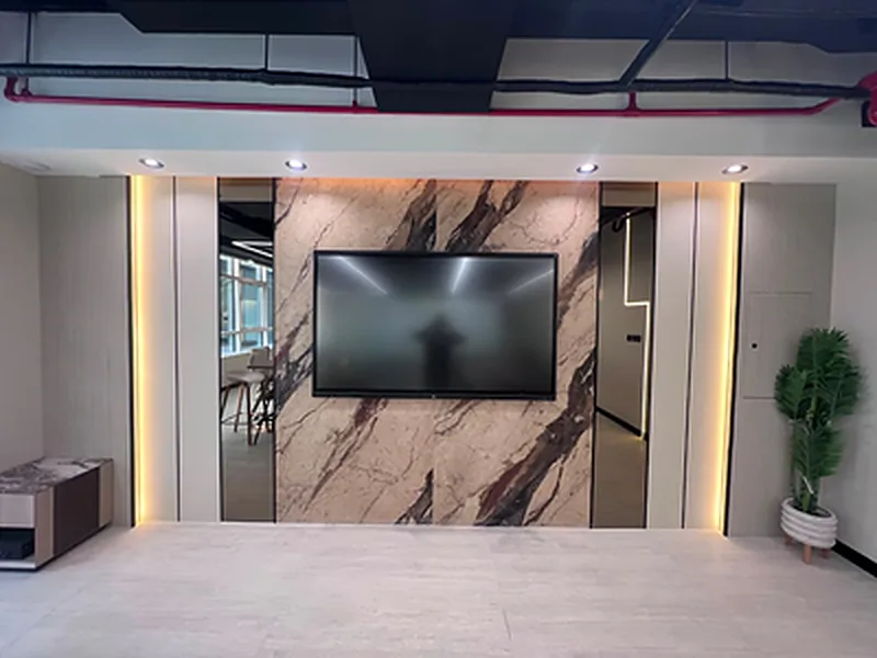 Marble-effect TV feature wall framed with warm LED strip lighting